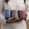 Three decorative scentsy candles in hand