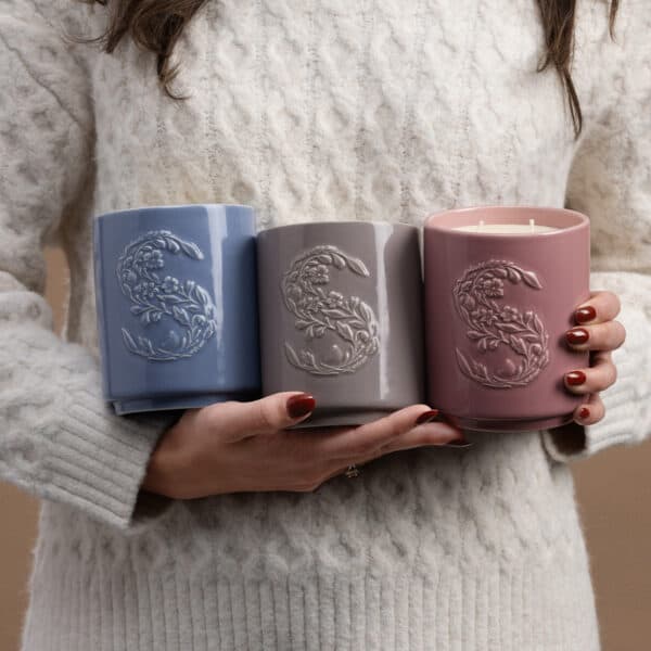 Three decorative scentsy candles in hand